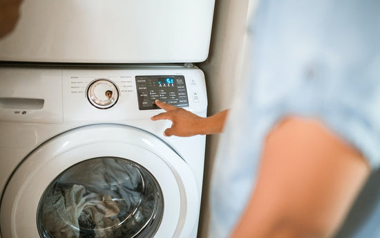 person using a washing machine
