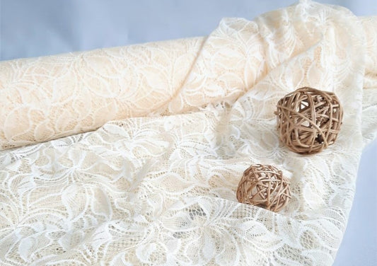 Champagne colored lace fabric lying on the ground