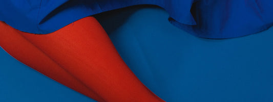 someone wearing red tights and a blue skirt on blue ground