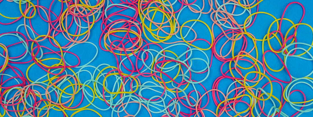 A bunch of colorful elastics lying on the blue ground