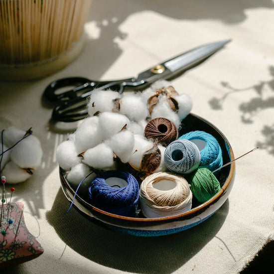 Bowl with sewing accessories lying on a table