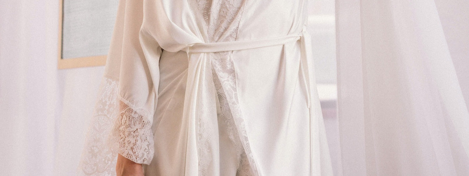 Woman wearing a white robe with lace trim